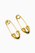 Pair of gold safety pins on a white background