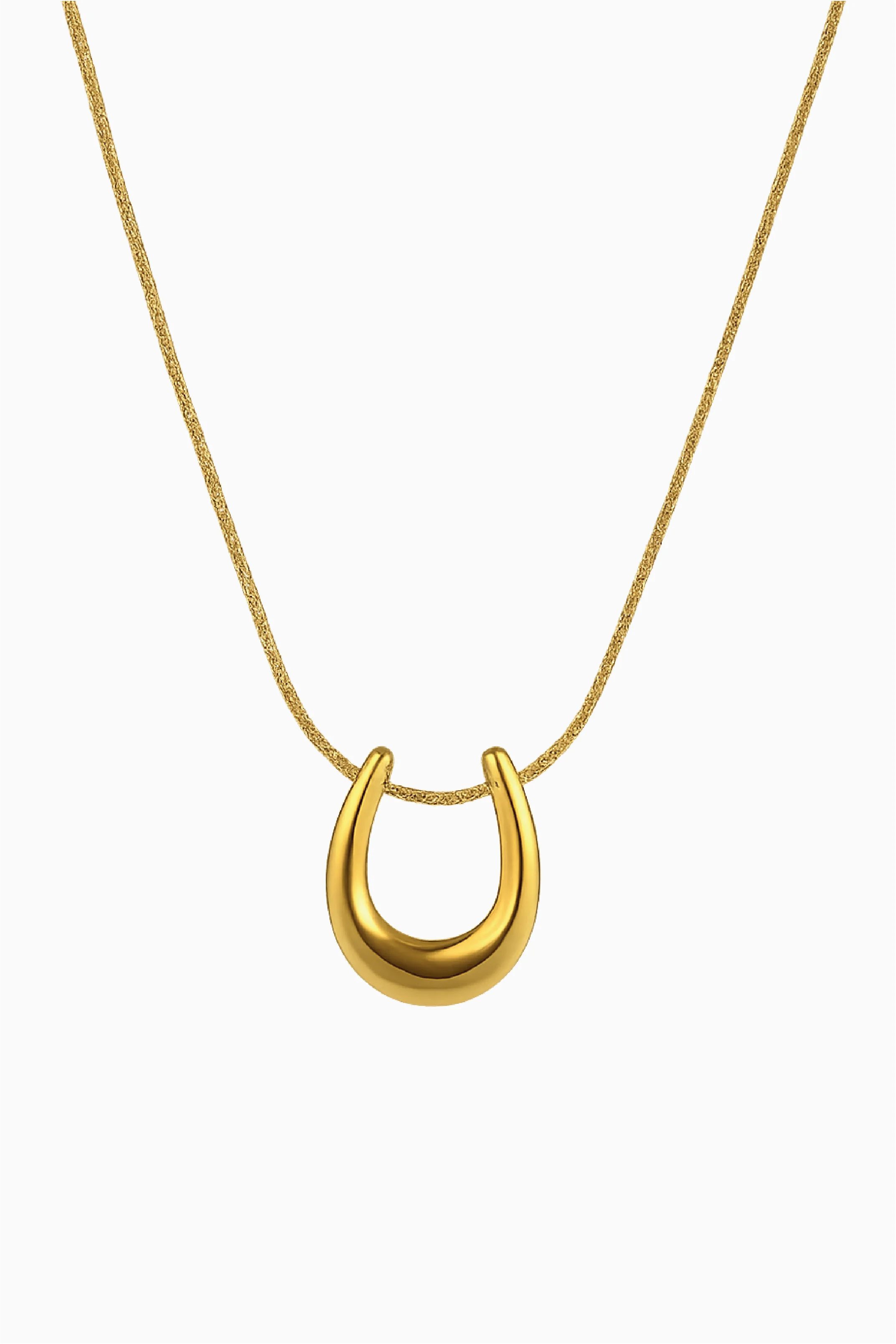Gold necklace with a U-shaped pendant on a white background