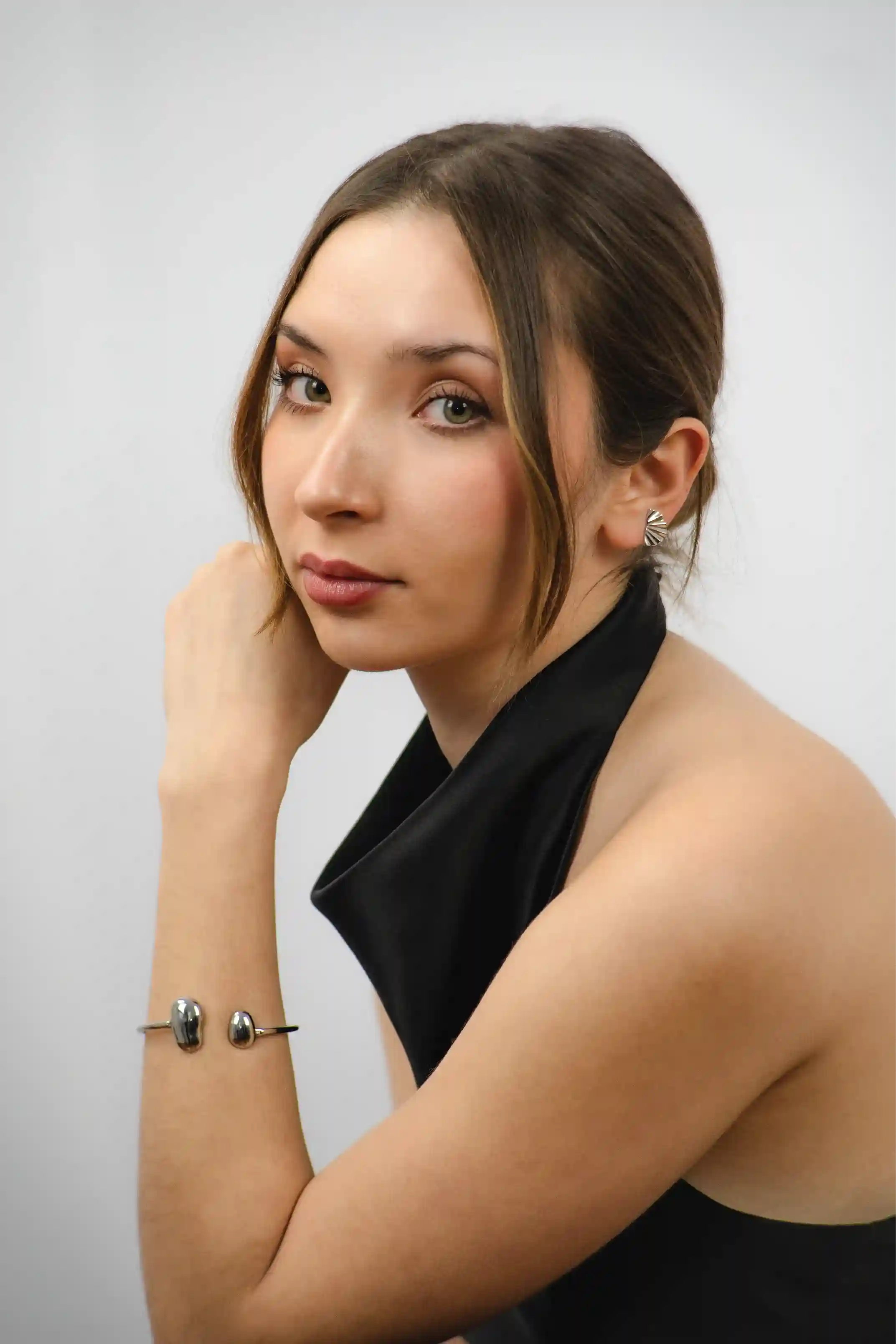Woman wearing a black top against a plain background