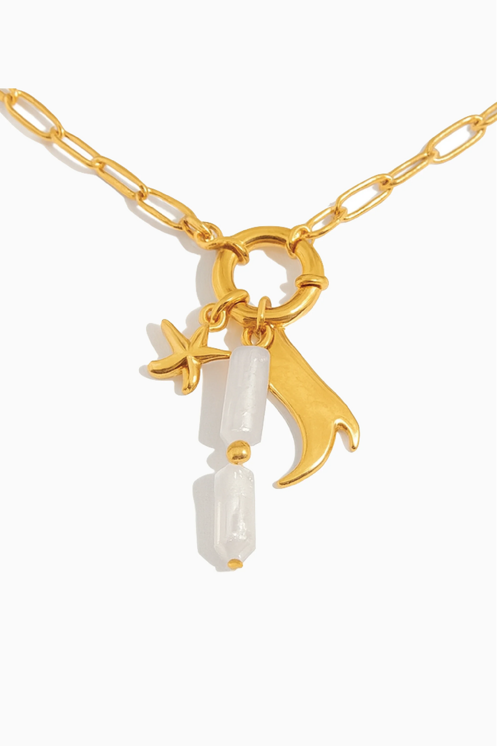 Gold necklace with star and moon charms on a white background