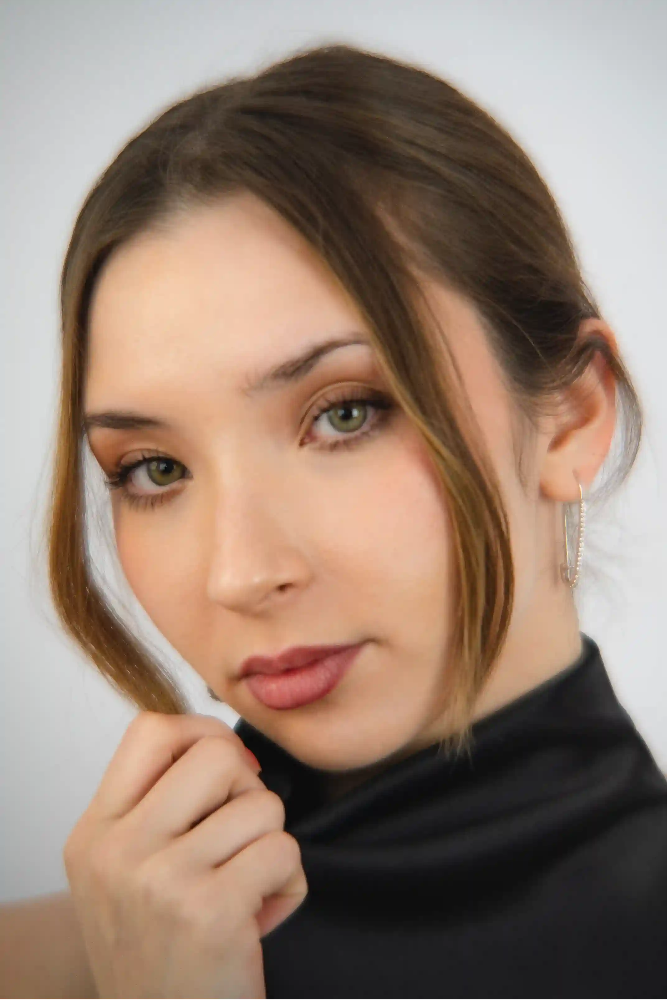 Woman with a neutral expression against a plain background