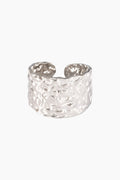 Silver textured ring on a white background