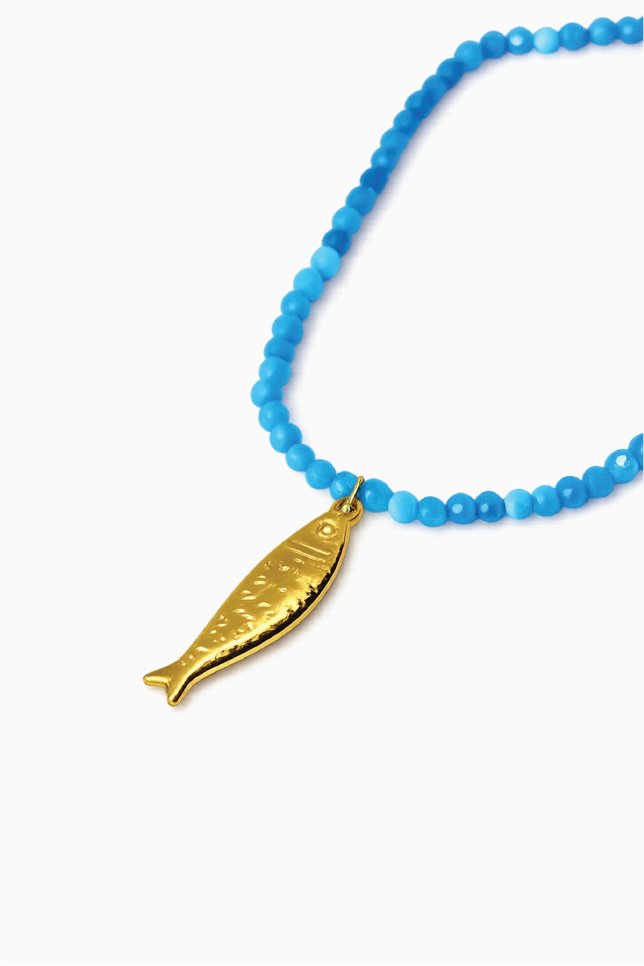 Blue beaded bracelet with a gold fish charm on a white background