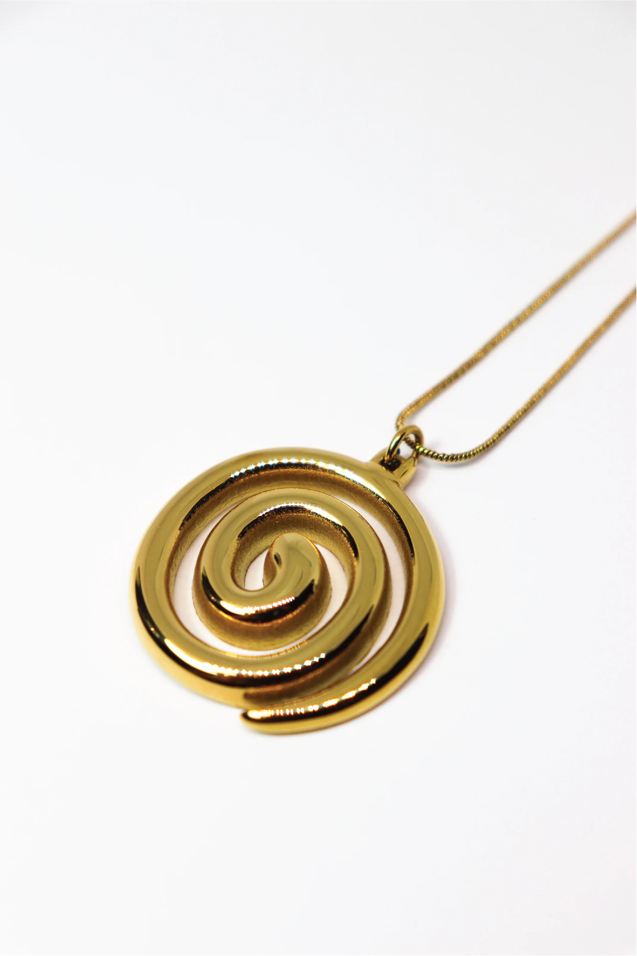 Gold spiral pendant on a white background